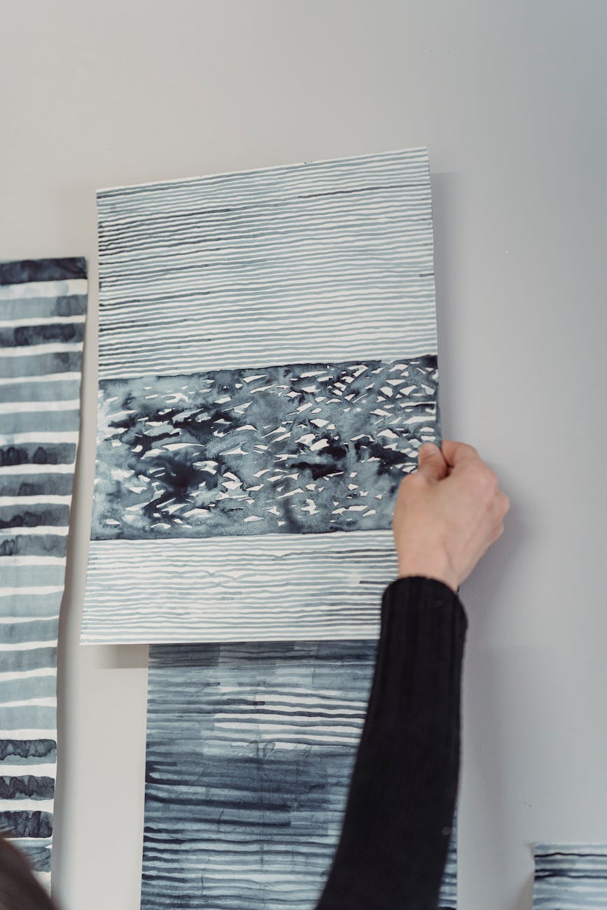 person holding an abstract painting